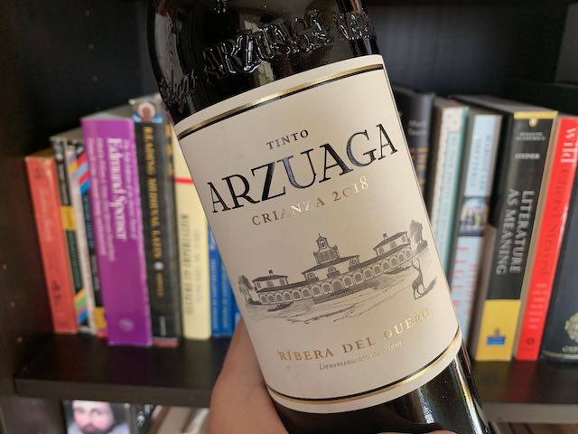 bottle of Tinto Arzuaga with books in background