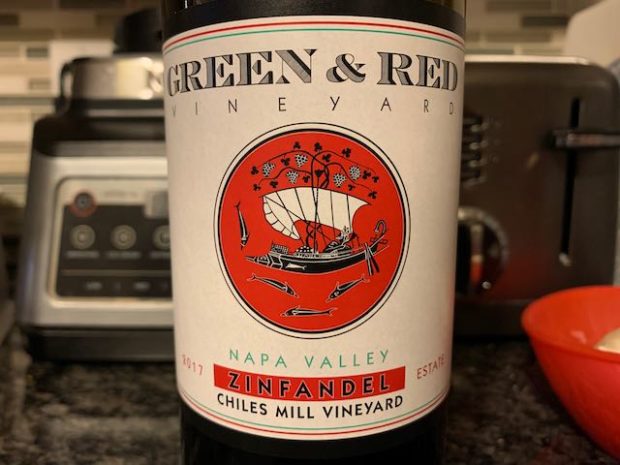 bottle of wine with greek style ship illustration on label