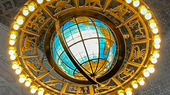 The chandelier at LAPL, with lights and zodiac surrounding a globe.
