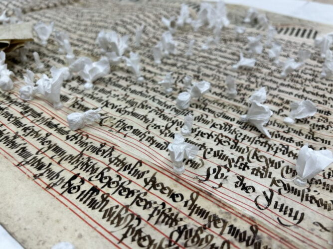 magets wrapped in tyvek on top of manuscript page