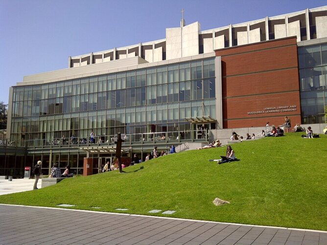 outside of the Lemieux Library building with grassy lawn in foreground